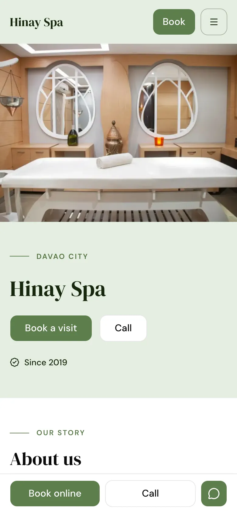 The website of Hinay Spa, a spa, on a phone, with a photo of a treatment room and a Book a visit button